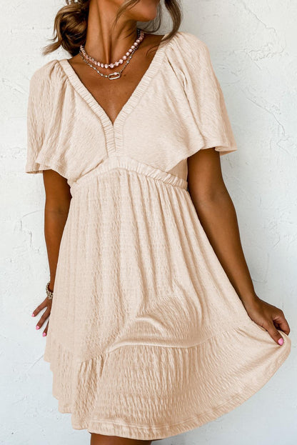 LP | Mini abito beige strutturato con profondo scollo a V per donne alla moda