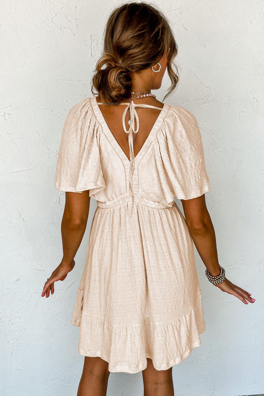 LP | Mini abito beige strutturato con profondo scollo a V per donne alla moda